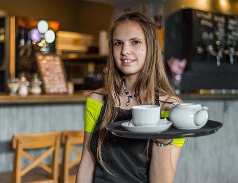A young female working in a coffee shop