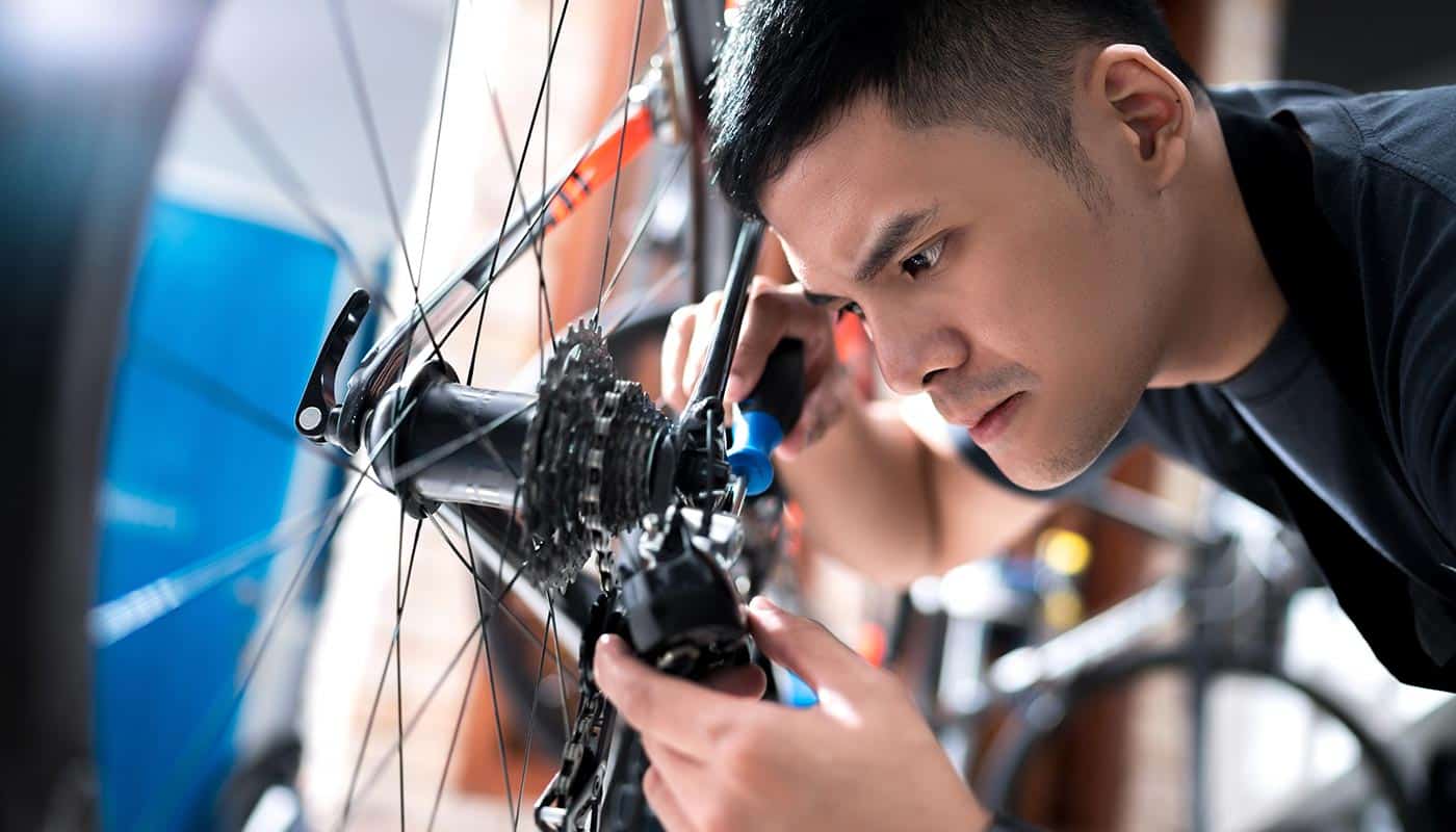 A young bicycle mechanic apprentice