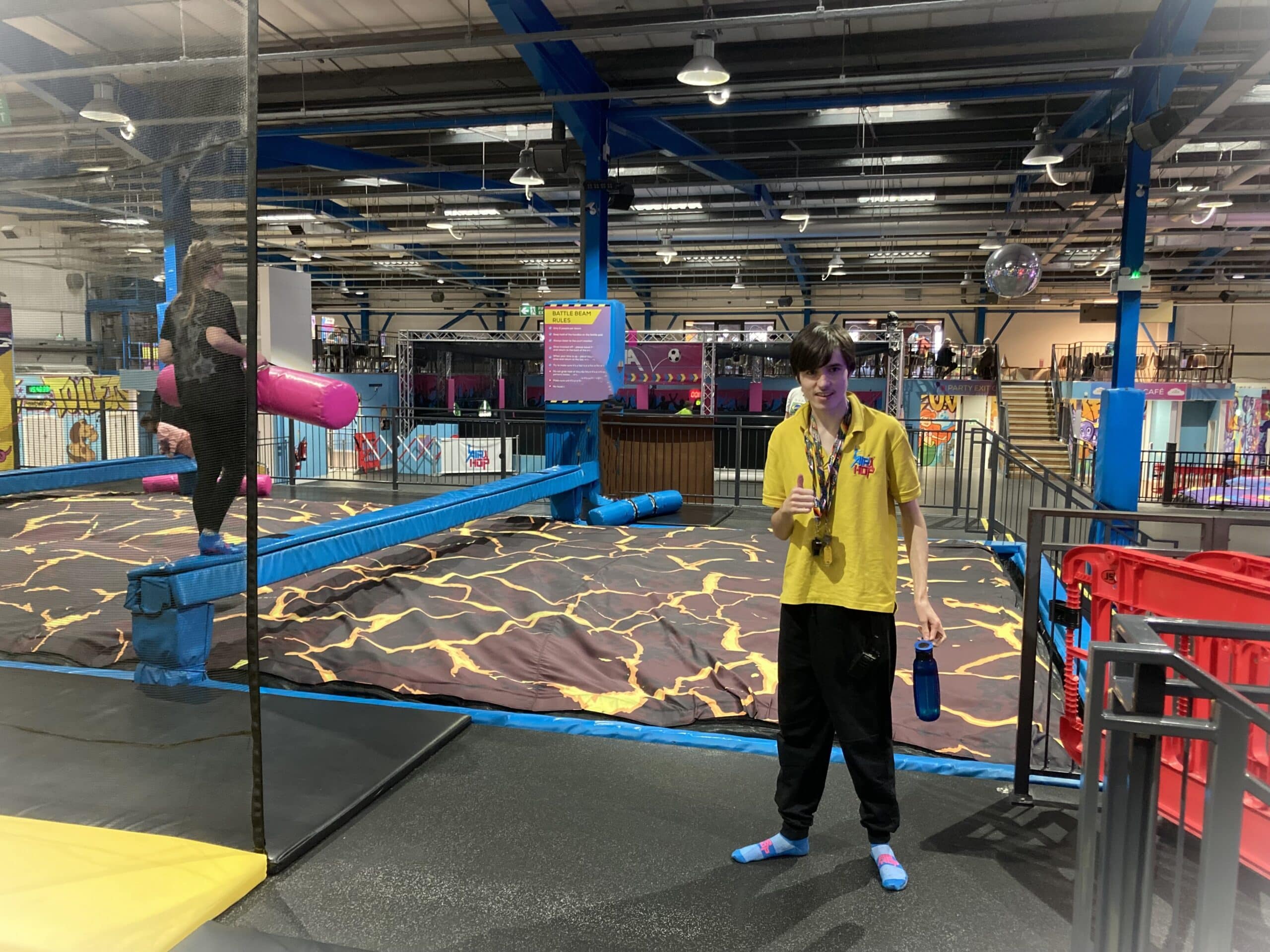 Young man working in a trampoline park